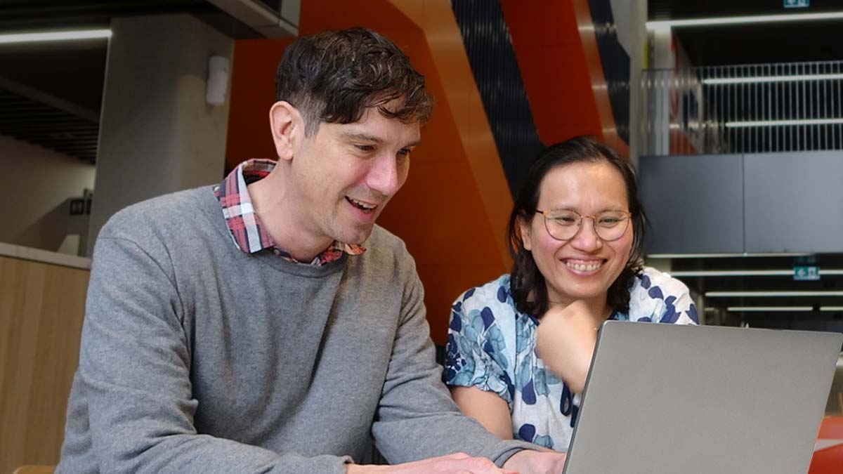 Julian and his supervisor preeyaporn working on a laptop