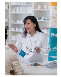 Photo of a pharmacist serving a customer in a pharmacy.