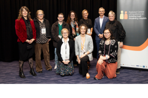 Photo of 10 people who work at the Centre. They are standing in a group and smiling at the camera.