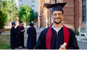 Photo of a postgraduate student in graduation robes.