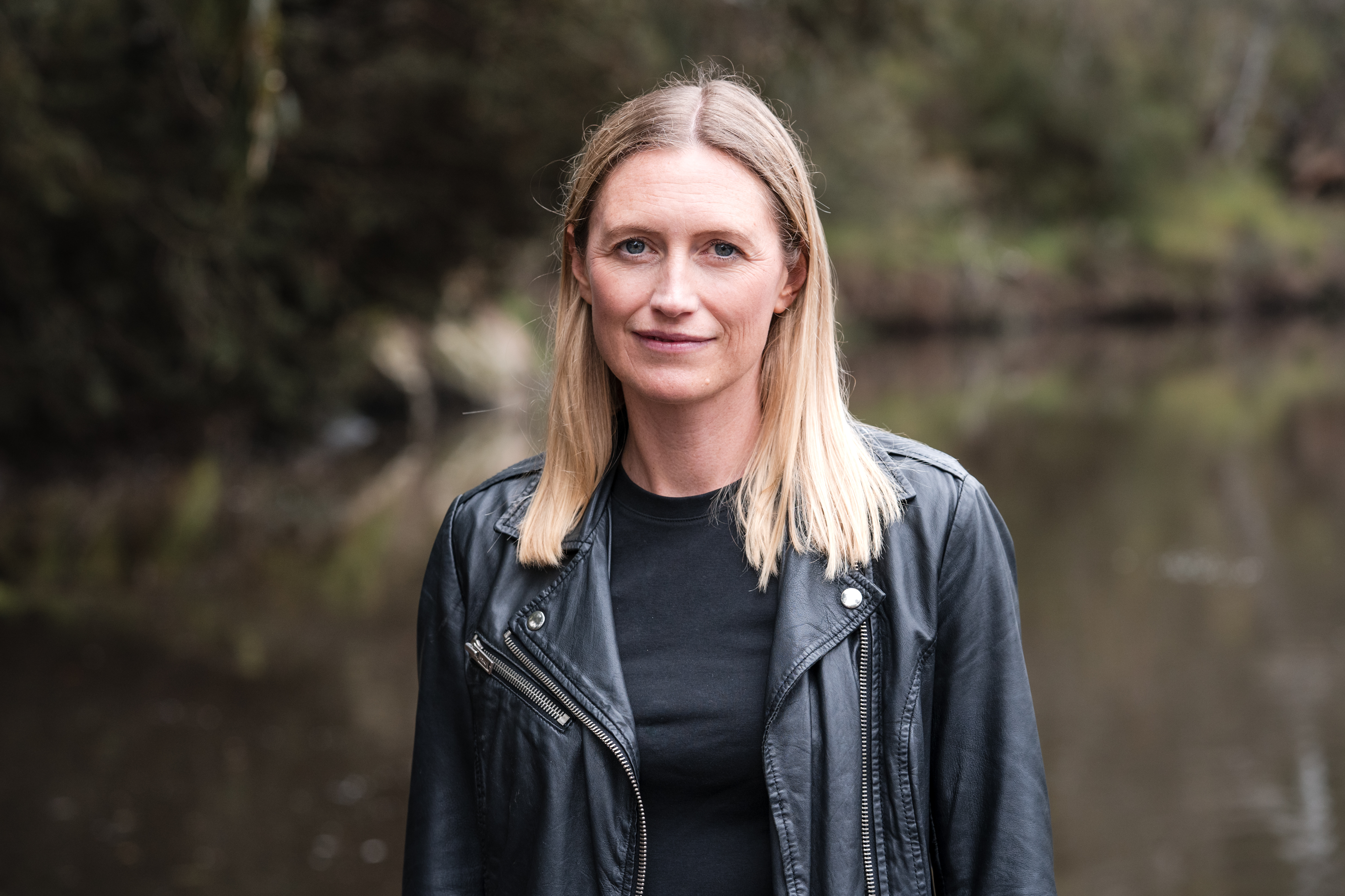 A photo of Zoe Aitken. She has long blonde hair and it wearing a black leather jacket.