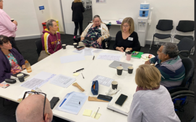 A group of people sitting around a table at the roundtable.