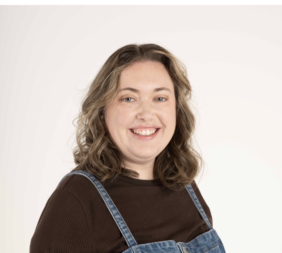 Photo of Alanna Julian. She is wearing a brown top and smiling at the camera.