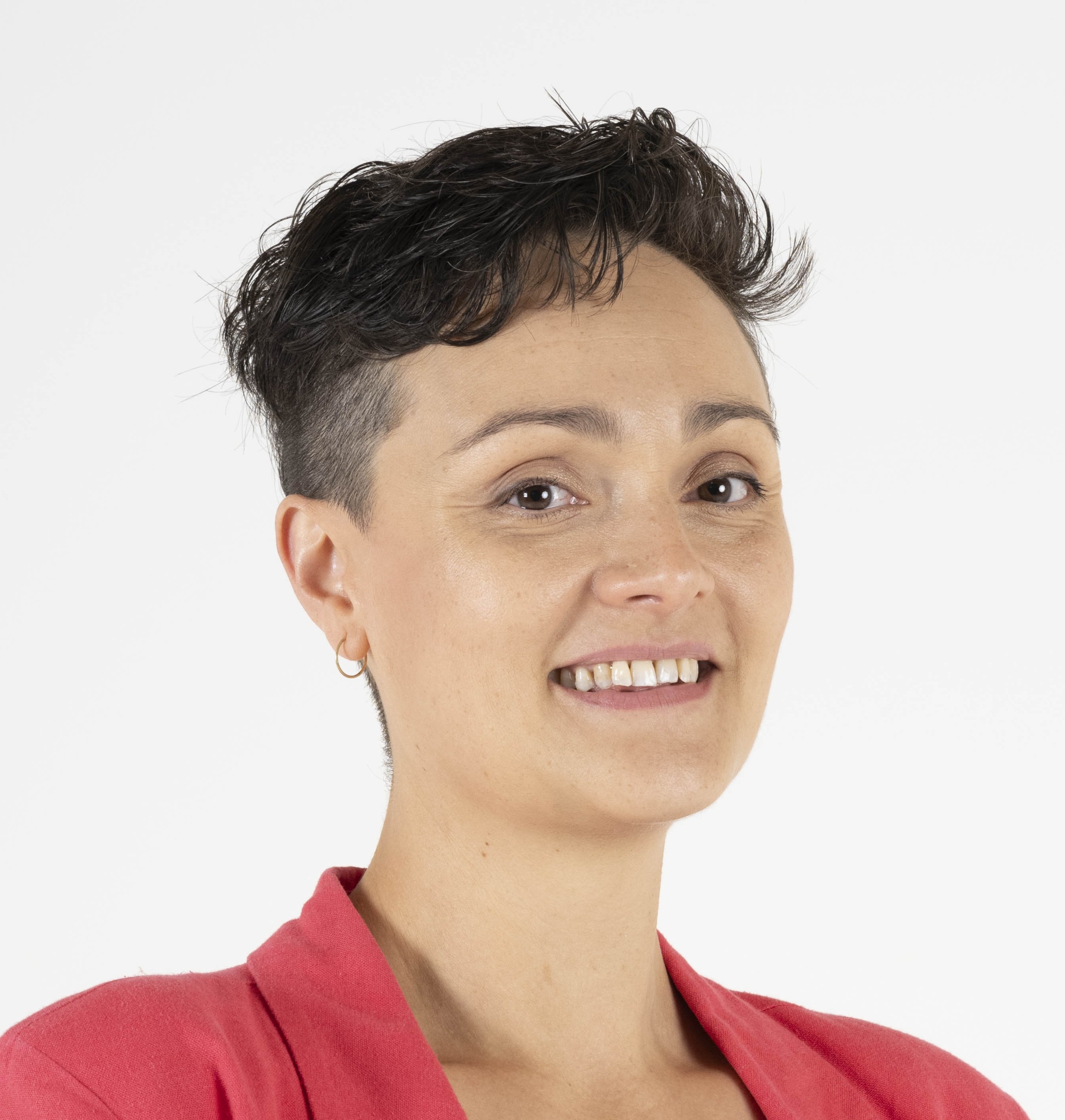 Photo of Cat Standley. She is wearing a pink top and smiling at the camera.