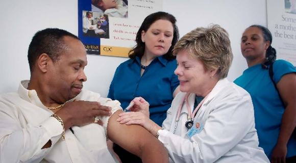 A doctor and nursing staff giving a preventive vaccination to a patient