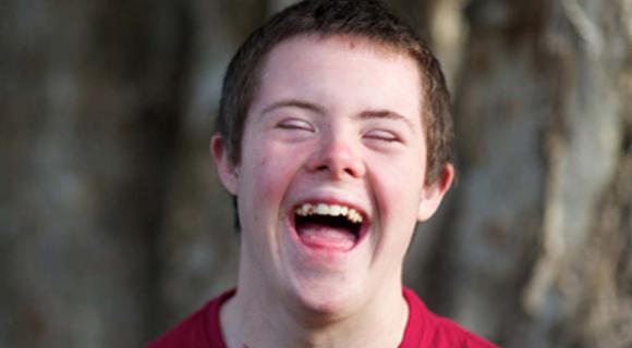 A young man with intellectual disability laughing