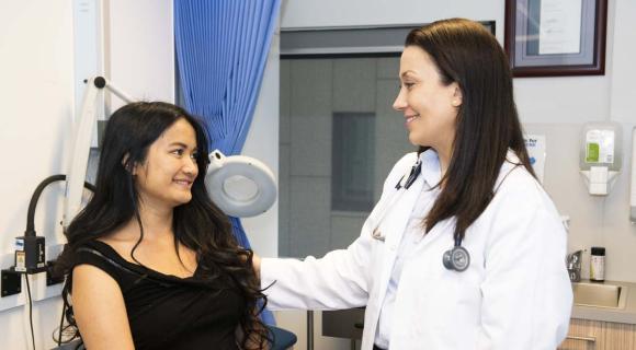 A doctor supporting a patient with intellectual disability in a medical clinic