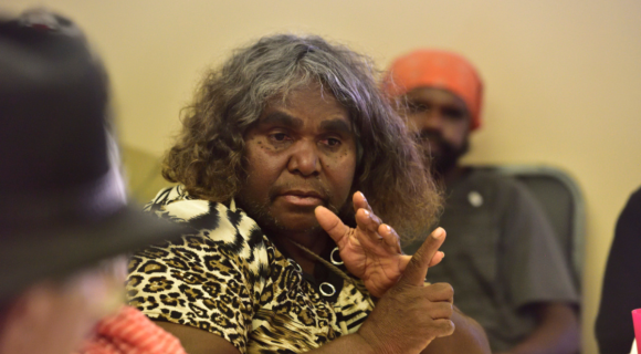 Photo of a First Nations woman listing things on her fingers.