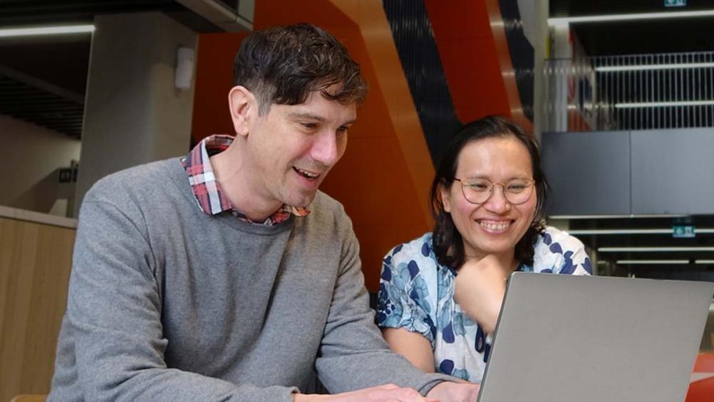 Julian and his supervisor preeyaporn working on a laptop