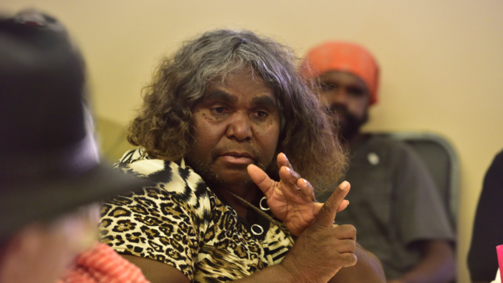 Photo of a First Nations woman listing things on her fingers.