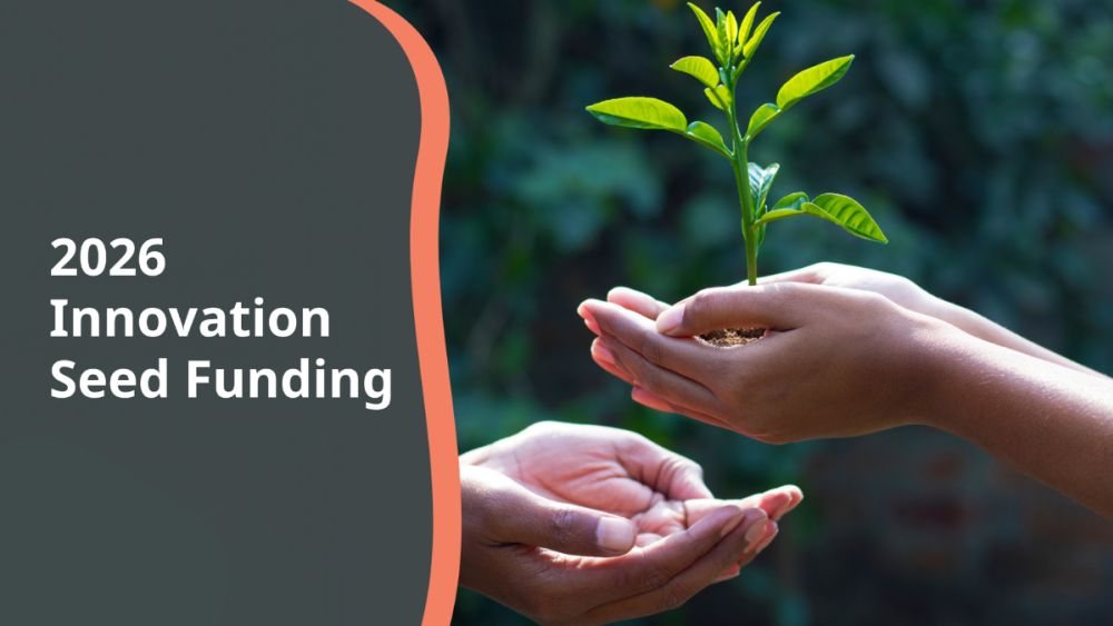 Dark grey banner with a photo of two hand on the right. One hand is holding a small plant. The words 2026 Innovation Seed Funding are on the left.