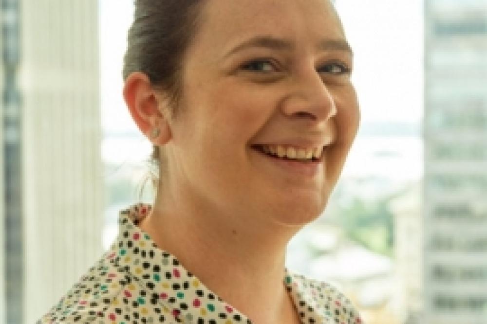 Head shot of Andrea Kargodorian. She is wearing a spotty top and smiling.